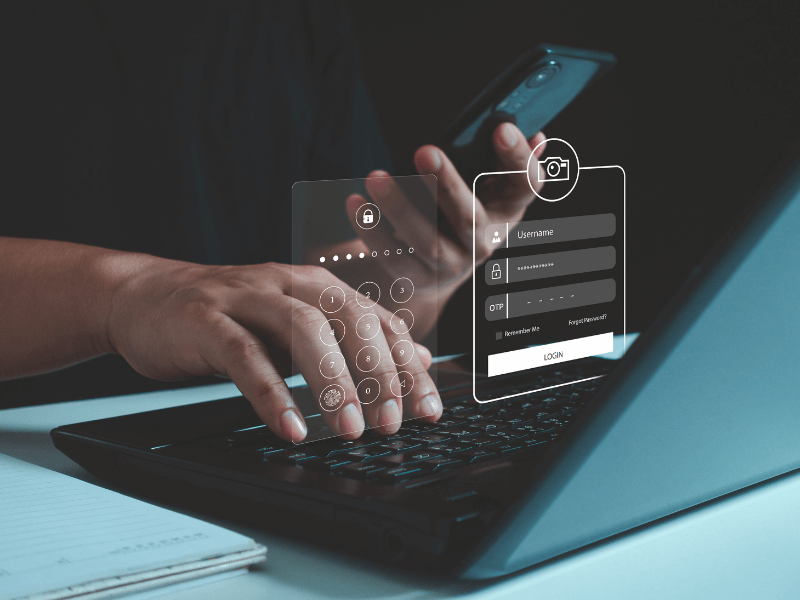 Person using a laptop with virtual interface overlays showing a numeric keypad and login fields.
