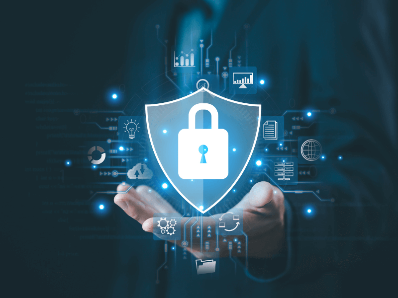 A digital shield with a padlock, symbolizing security, surrounded by tech icons and held by a hand.