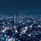 Nighttime cityscape with a digital network overlay.